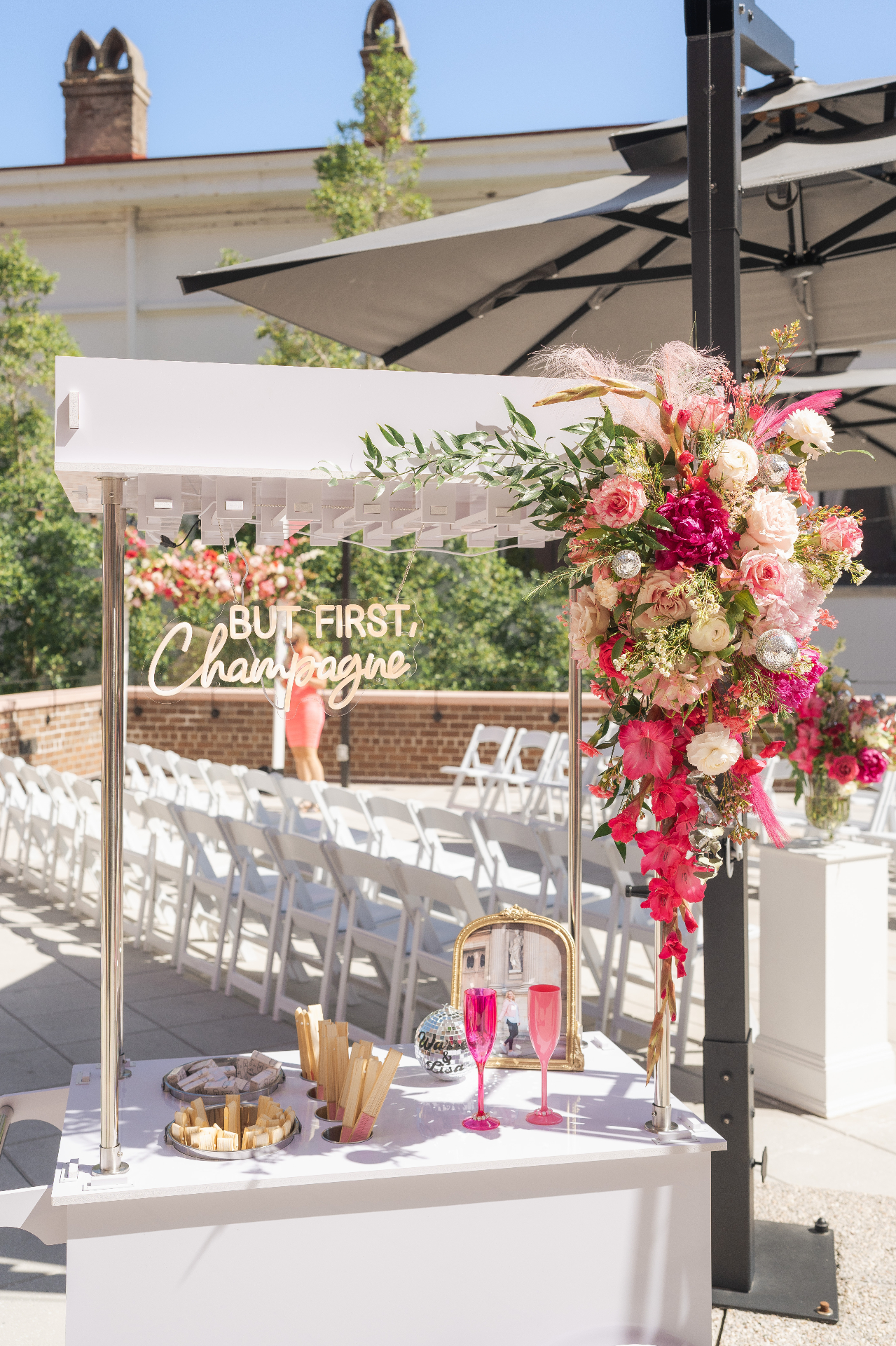 Elegant champagne cart with floral arrangements at an outdoor event