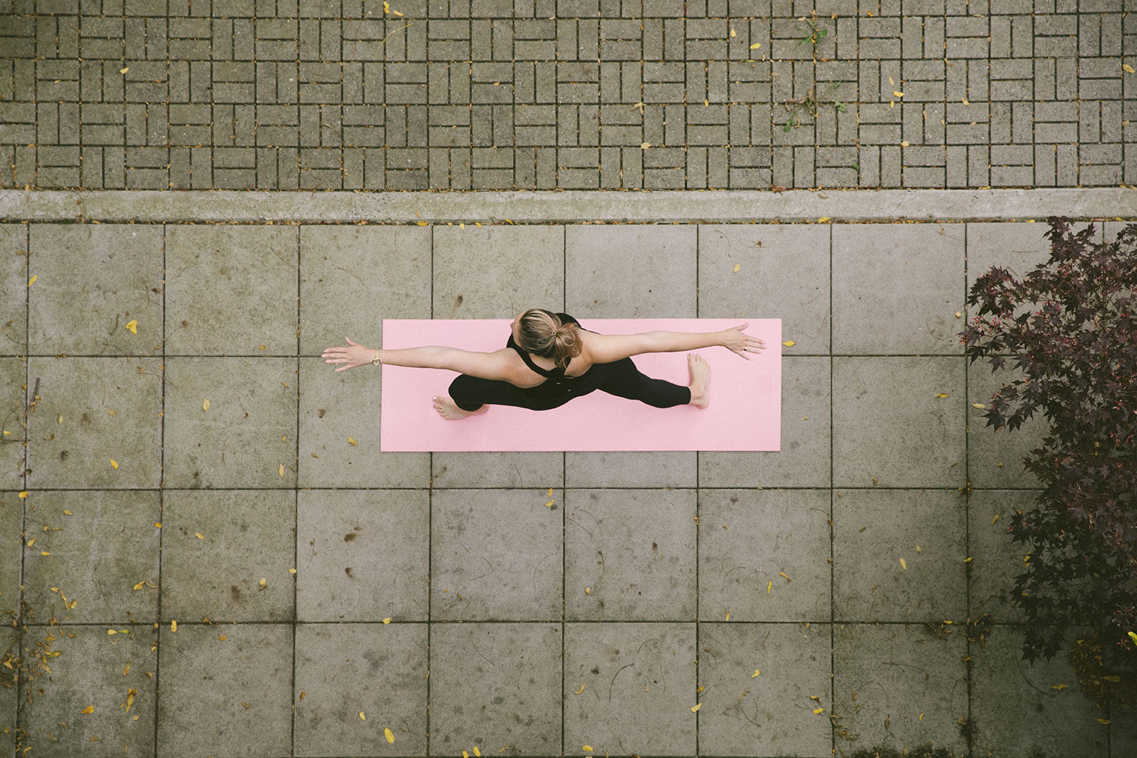 Yoga session on a pink mat outdoors